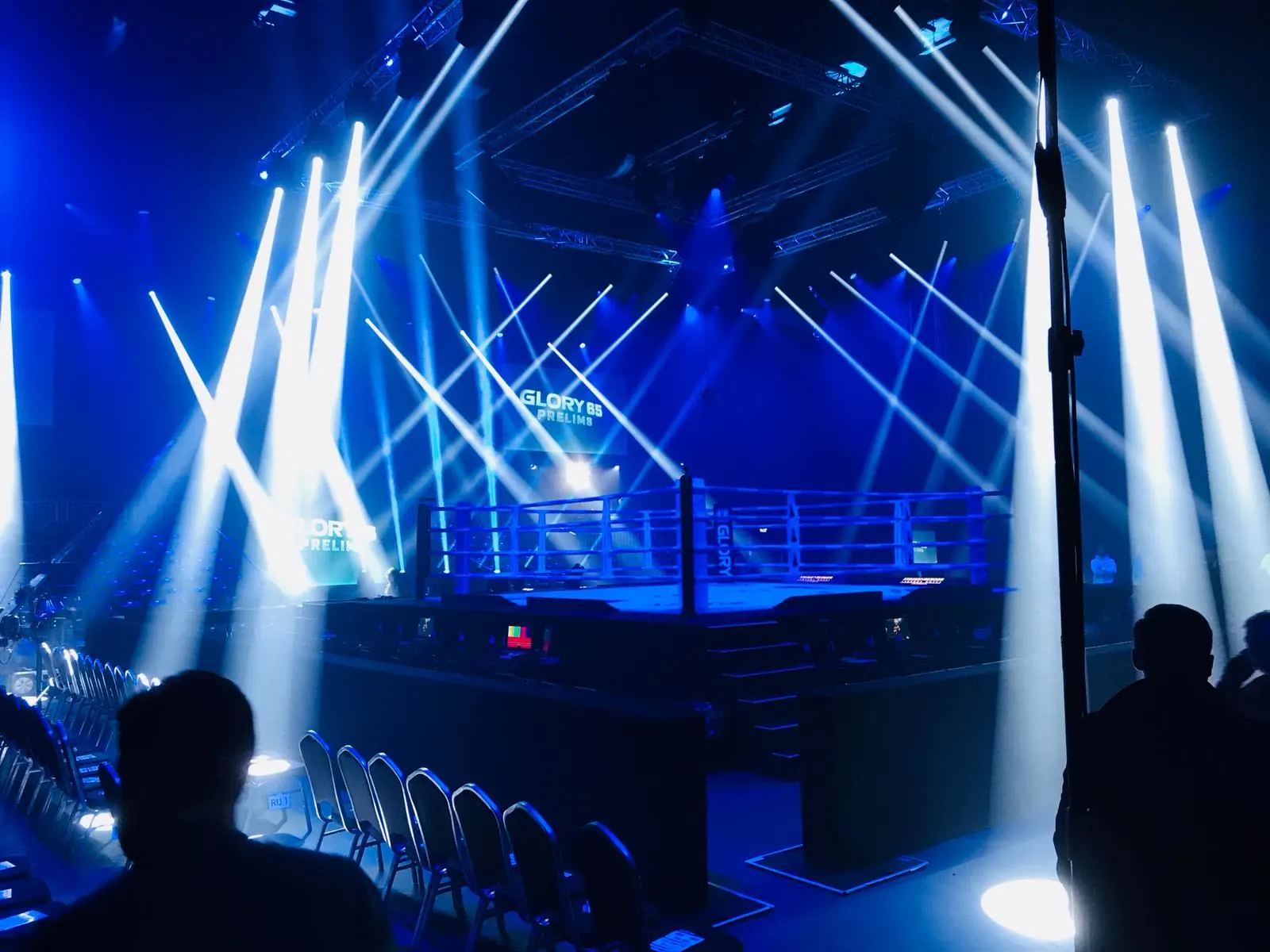 Boxing ring in blue light with light beams