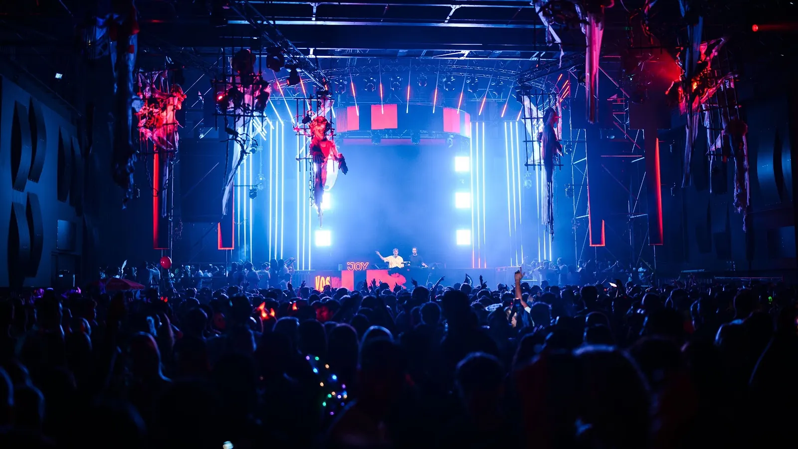 Lit stage and a packed hall during a party