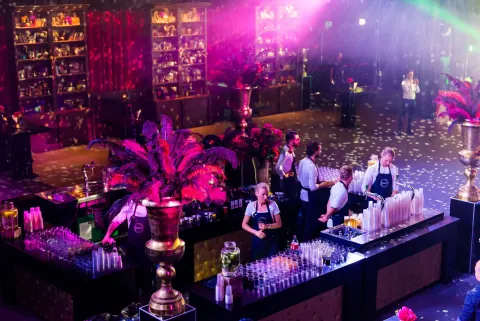 Guests at a bar with flower arrangements